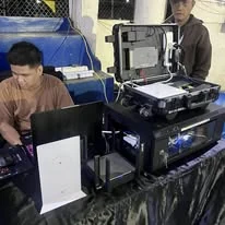 A TINKIT technician configuring equipment on site
