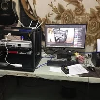A workbench with a small rack and a monitor, setting up a link