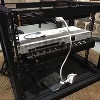 A small rack with a router and patch cables, ready to deploy