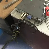 The back of a CCTV recorder with its camera cables tied in