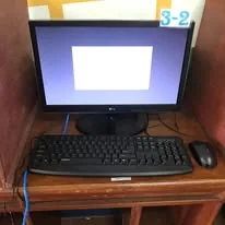 A finished computer station labelled 3-2 with monitor, keyboard and mouse
