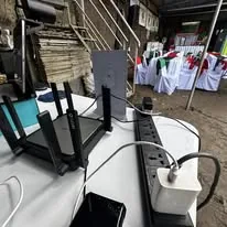 A Wi-Fi router and power strip on the event's tech table