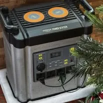 A portable power station beside a Christmas tree